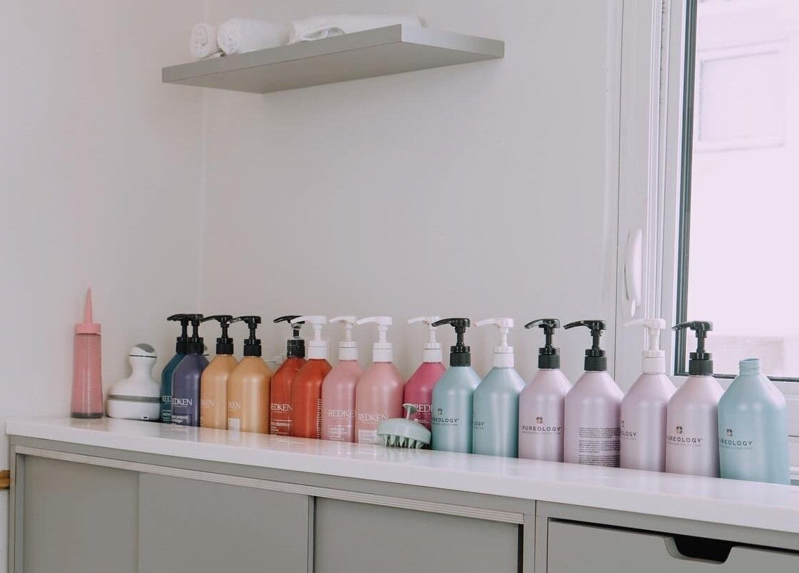 Variety of hair care products displayed at Blowbar in San Juan, San Juan, PR, on a white shelf.
