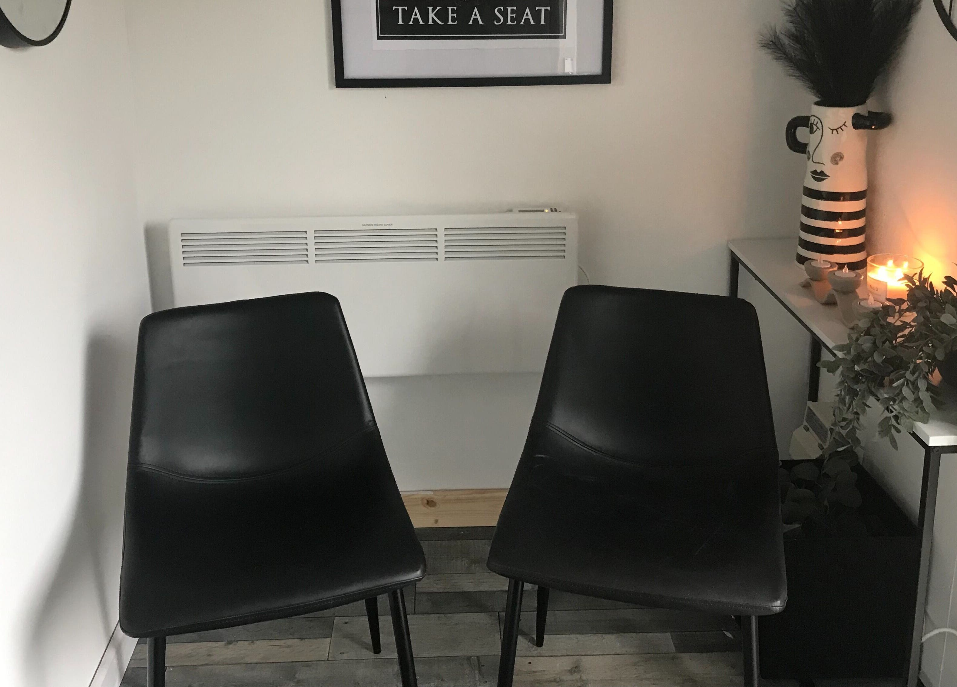 Cozy seating area at Elaine Ferris Waxing & Beauty Studio, Bishopbriggs, Scotland, GB with candles and decor.