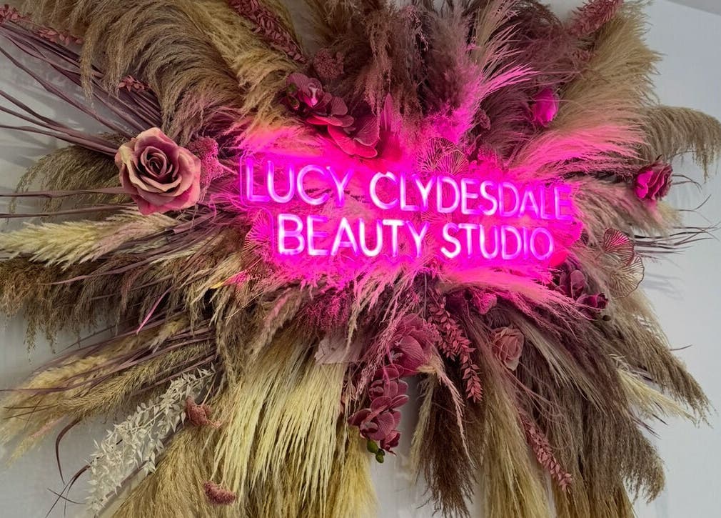 Lucy Clydesdale Makeup Brows Lashes neon sign with floral decoration in Yarm, England, GB.