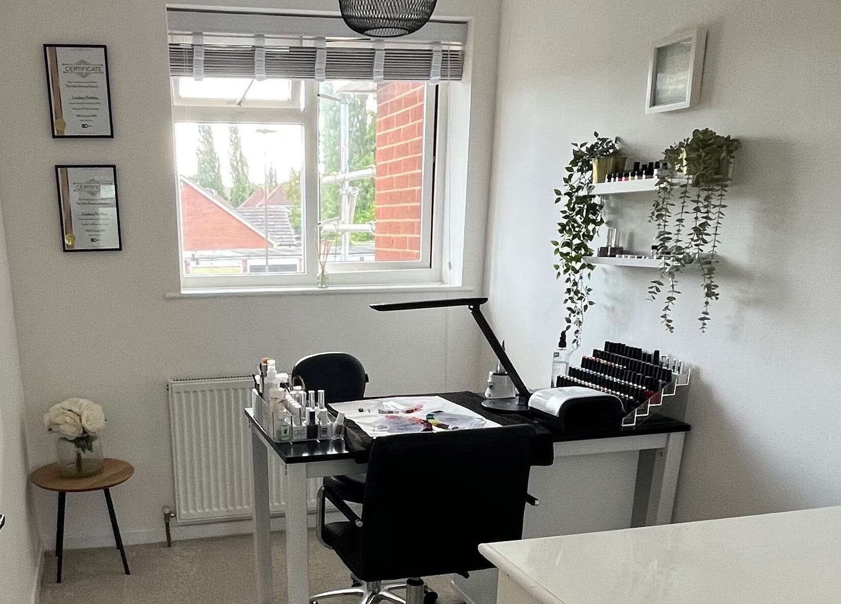 Modern nail salon interior at Lindsays Nails Birmingham, Birmingham, England, GB with minimalist decor and greenery.