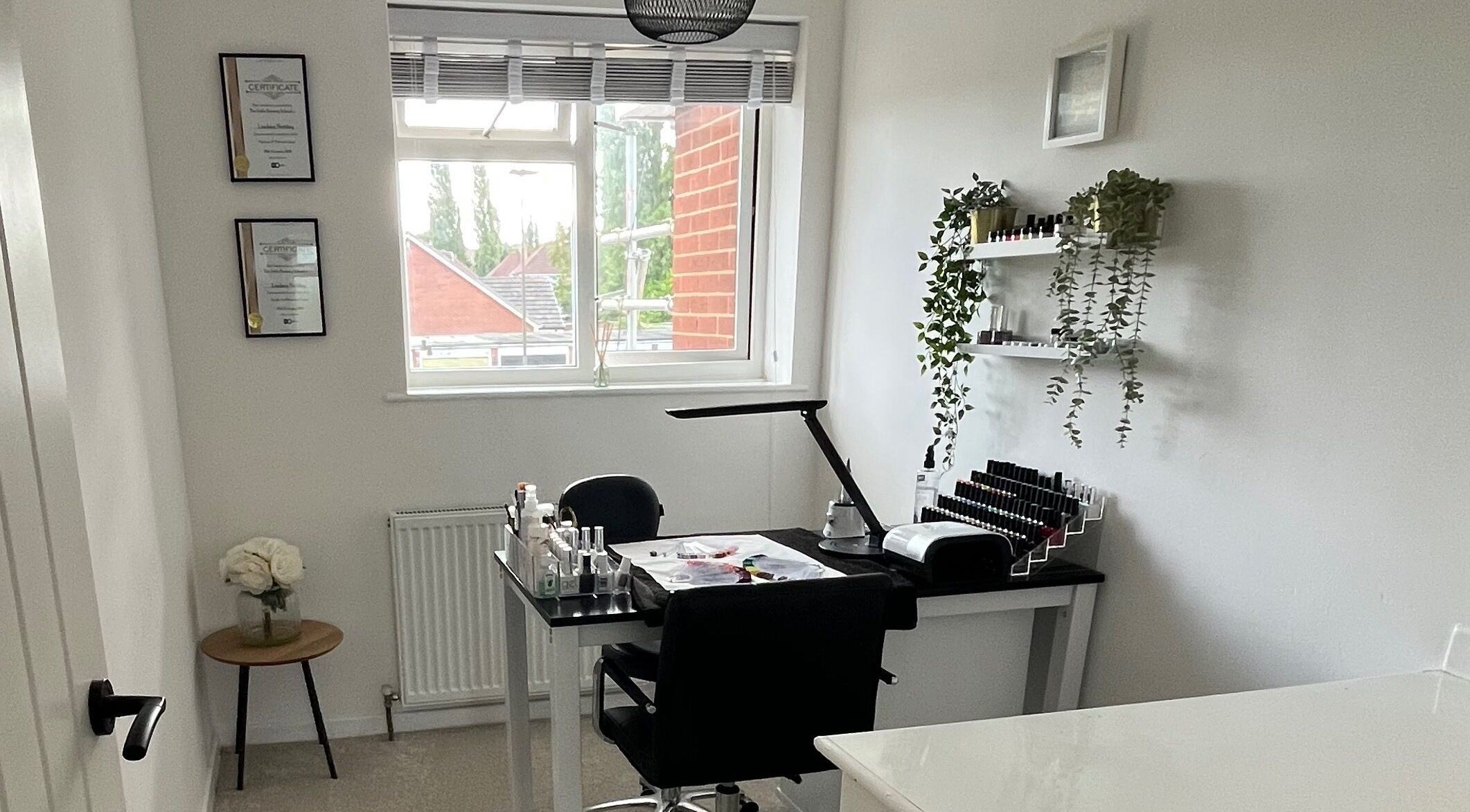 Modern nail salon interior at Lindsays Nails Birmingham, Birmingham, England, GB with minimalist decor and greenery.