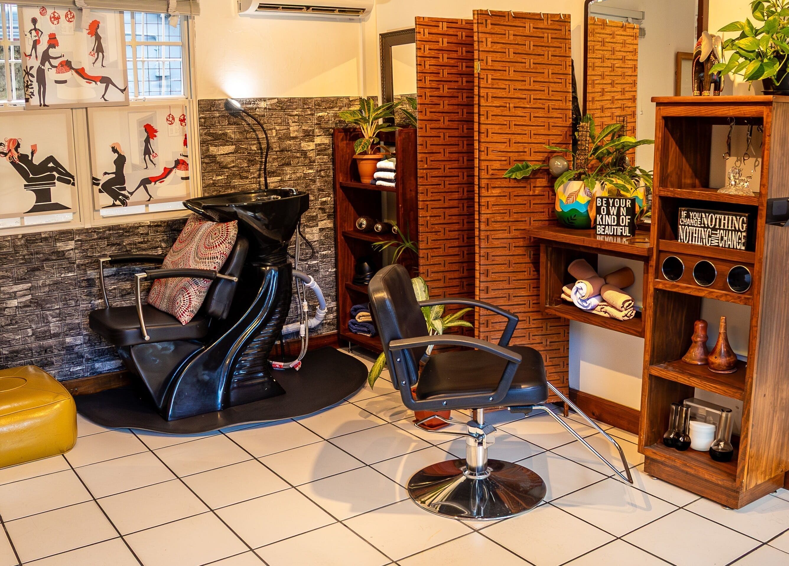 Chic salon corner at Studio40, Port of Spain, featuring stylish chairs and decor for a relaxing experience.