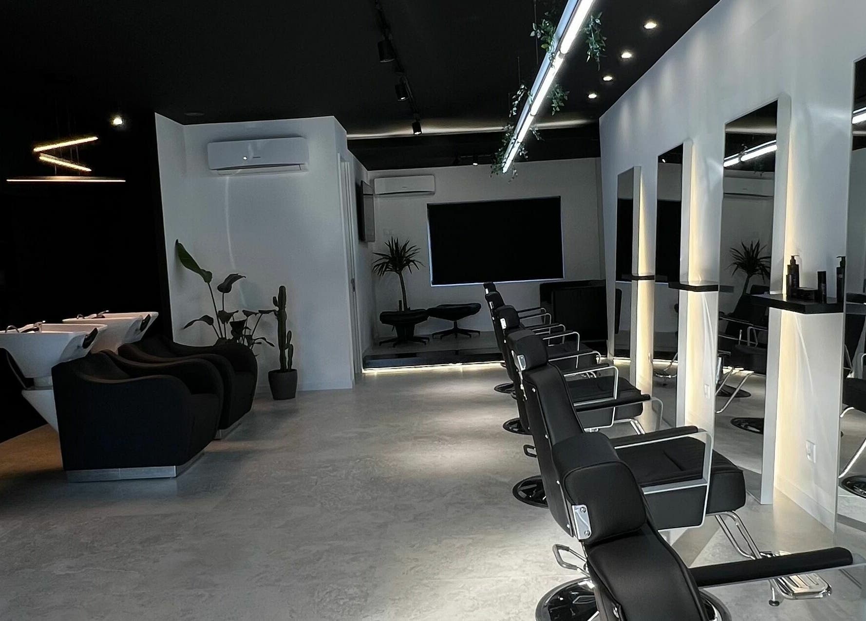Interior moderno do Blend Men's Salon | Taipas em Guimarães, PT, com cadeiras de barbearia e estética elegante.