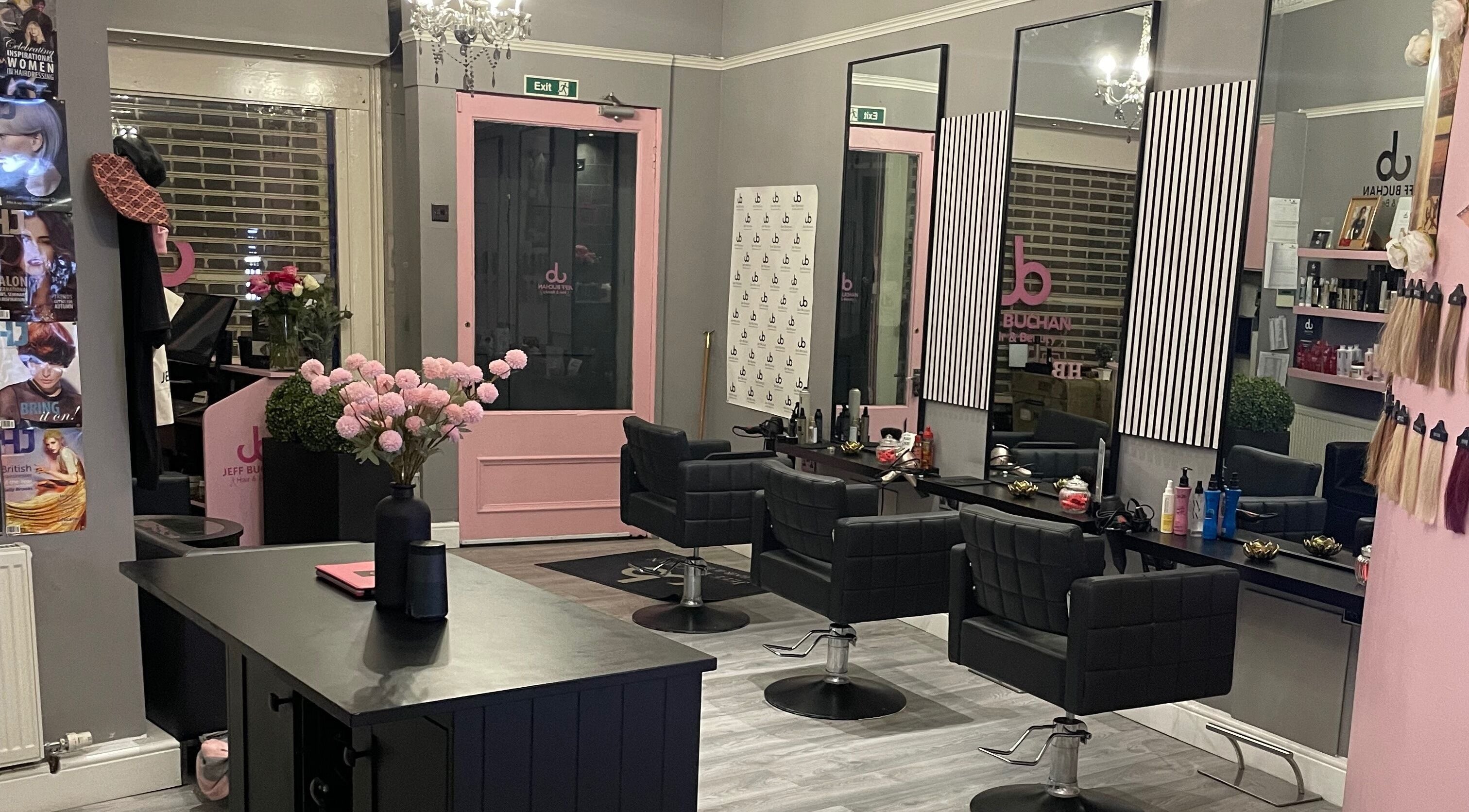 Modern salon interior at Jeff Buchan Hair, Stirling, Scotland, GB with stylish chairs and decor.