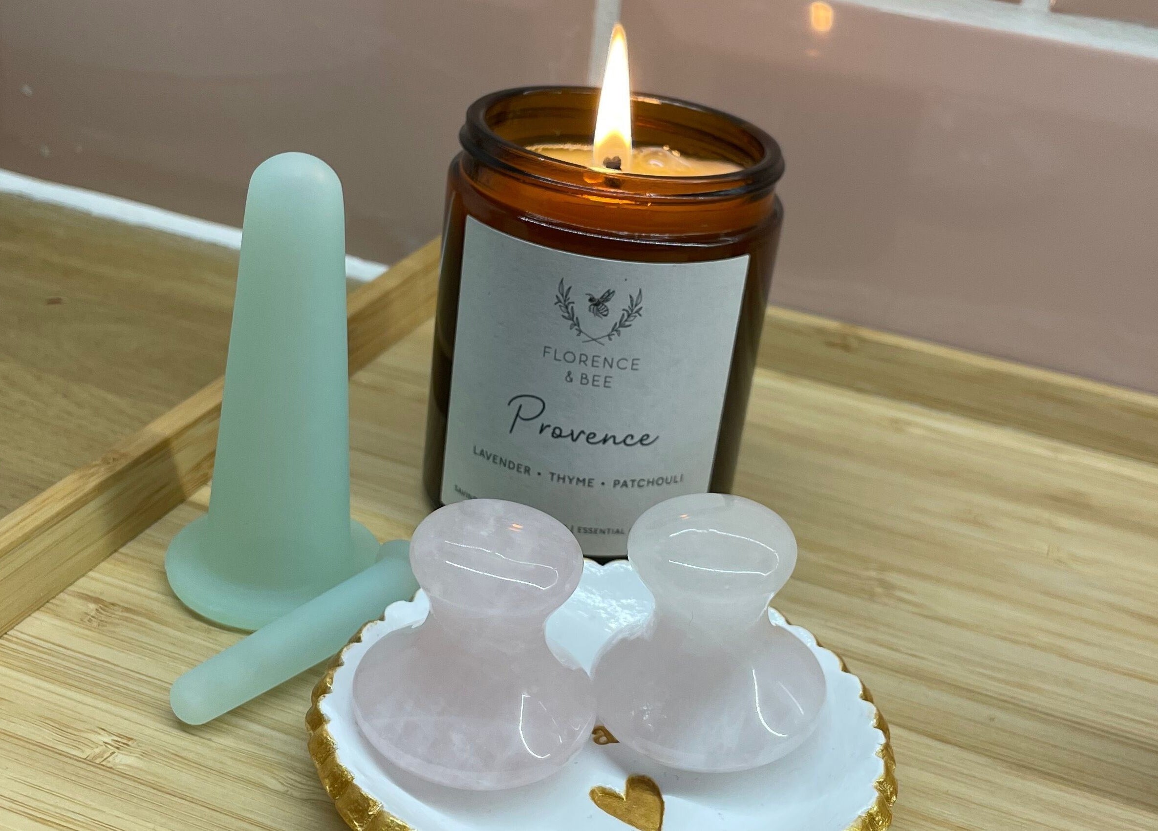 A lit candle and wellness tools at The Skin and Beauty Studio, Beaconsfield, England, GB.