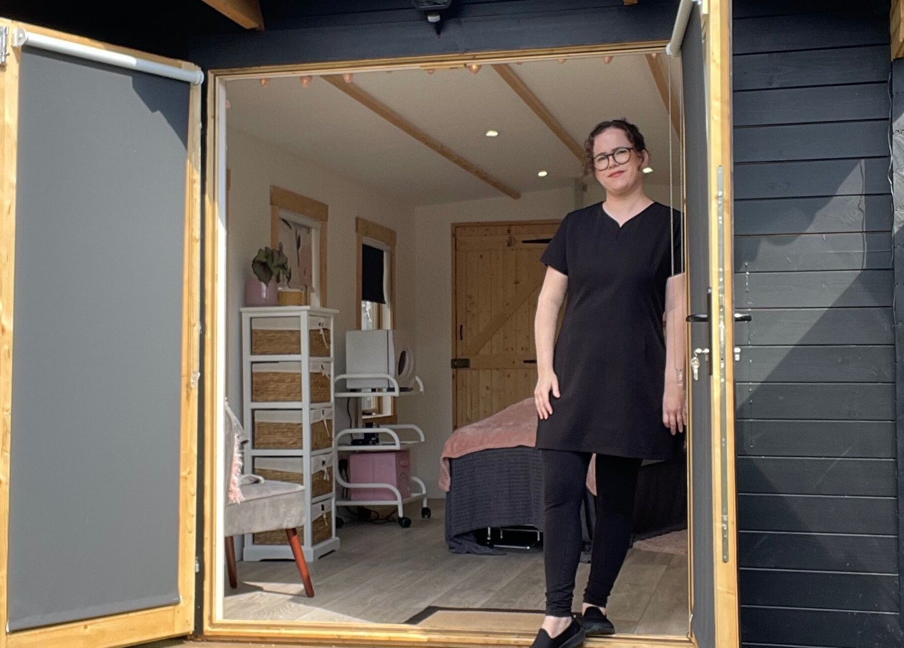 Staff member at The Skin and Beauty Studio, Beaconsfield, England, GB, welcomes guests at open door.