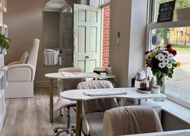 Elegant interior of Beauty By Anna Ashley at Beauty & Co, Abbot’s Langley, GB, featuring chic decor and floral display.