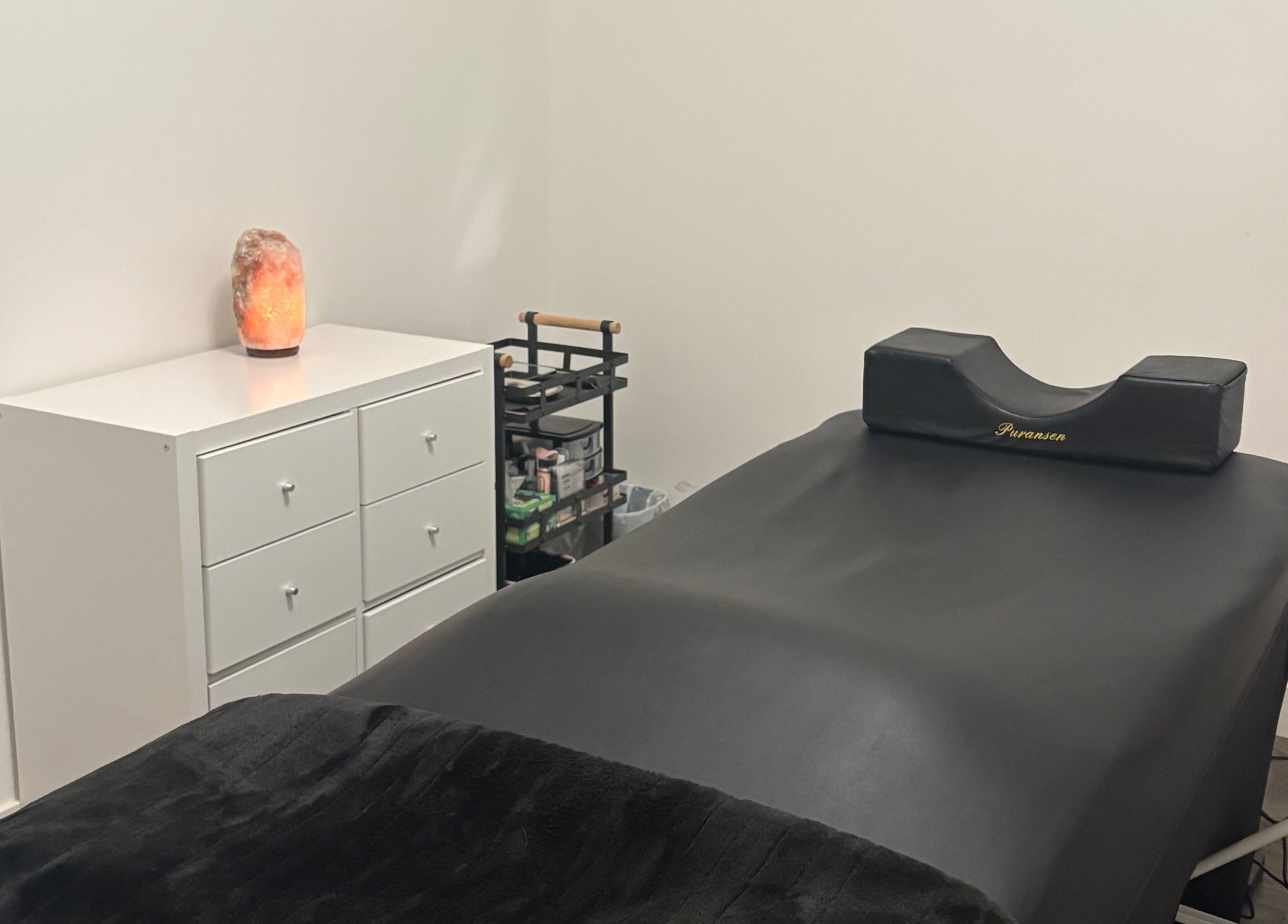 Relaxing eyelash extension room at Lash Alley YYC, Calgary, Alberta, CA with a massage bed and salt lamp.