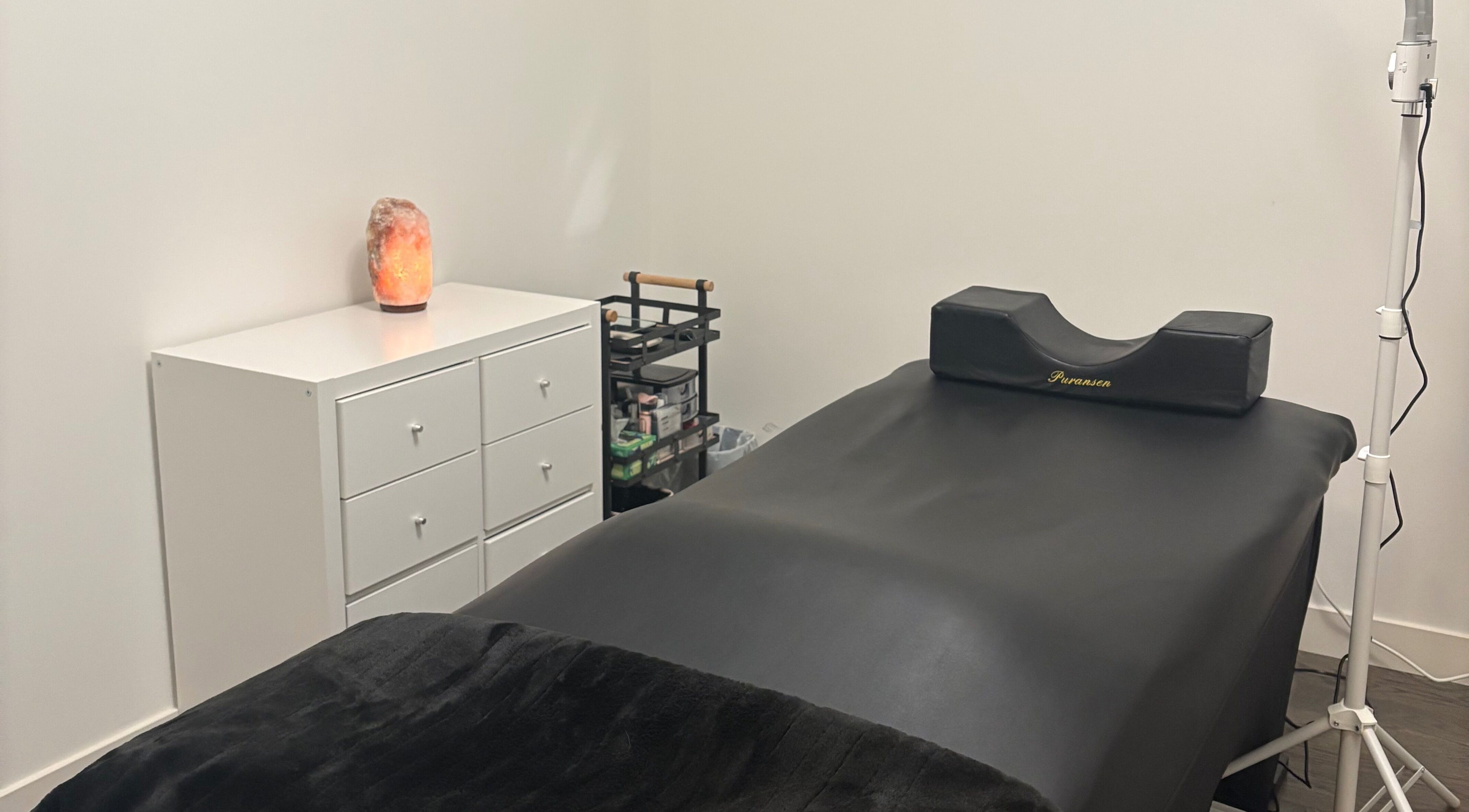 Relaxing eyelash extension room at Lash Alley YYC, Calgary, Alberta, CA with a massage bed and salt lamp.