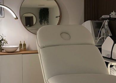 Modern treatment room at The Contour Clinic in Irlam, England, GB featuring a sleek chair and advanced beauty equipment.