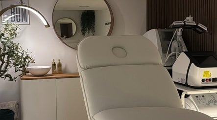 Modern treatment room at The Contour Clinic in Irlam, England, GB featuring a sleek chair and advanced beauty equipment.