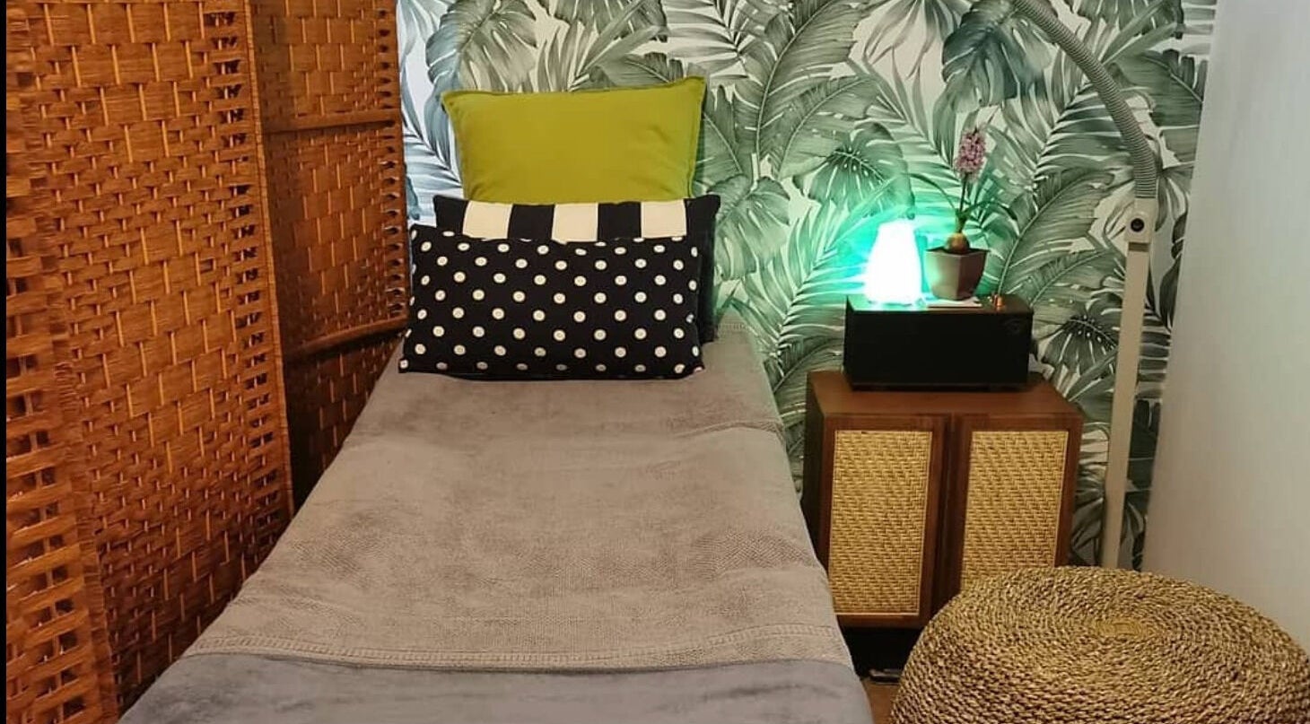 Cozy treatment room at The Organic Room SG (Bugis), Singapore, SG, featuring tropical decor and serene ambiance.