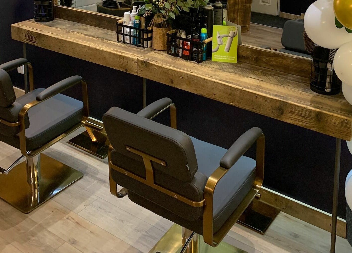 Stylish salon chairs and wooden counter at Headhouse, Horsforth, England, GB, showcasing modern elegance.