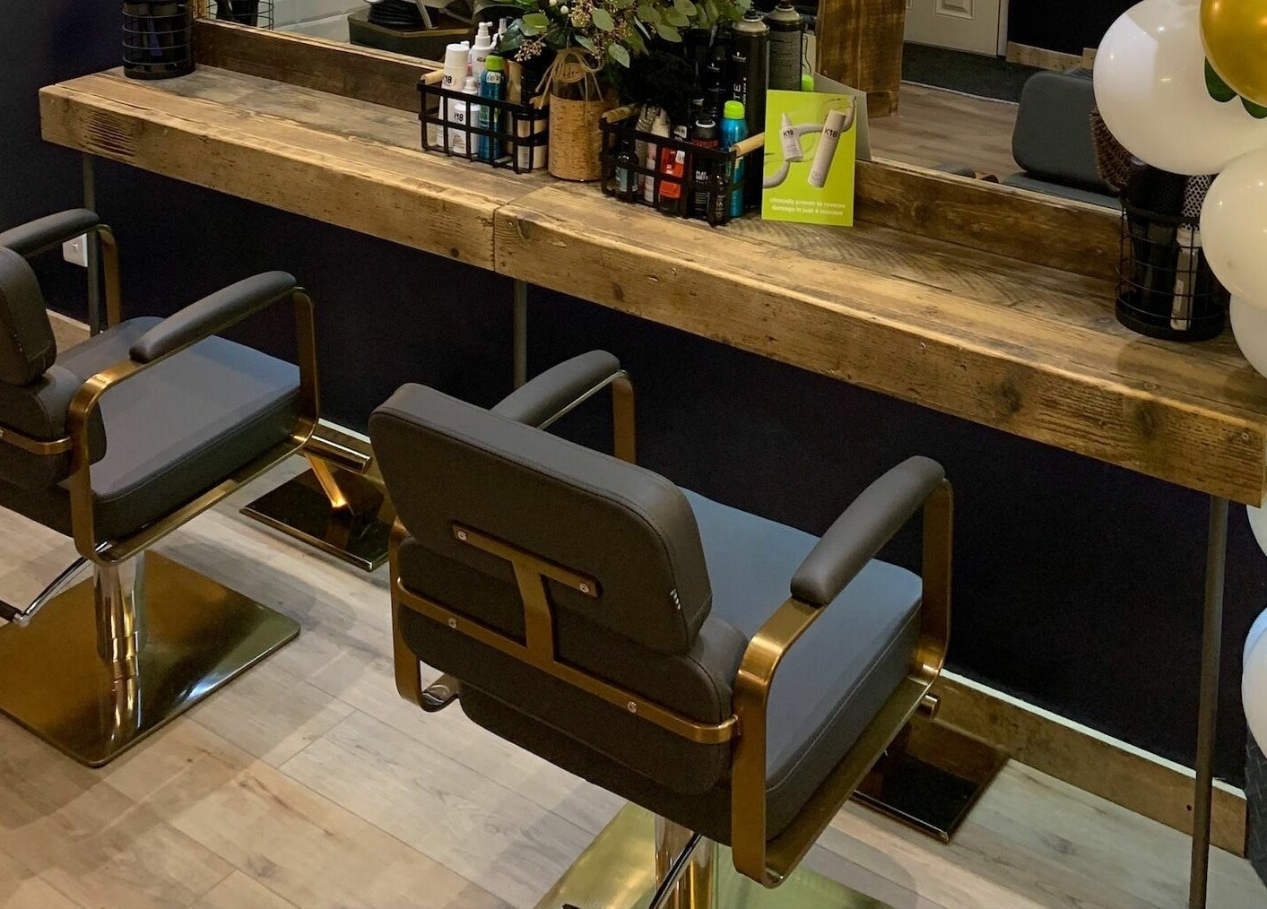 Stylish salon chairs and wooden counter at Headhouse, Horsforth, England, GB, showcasing modern elegance.