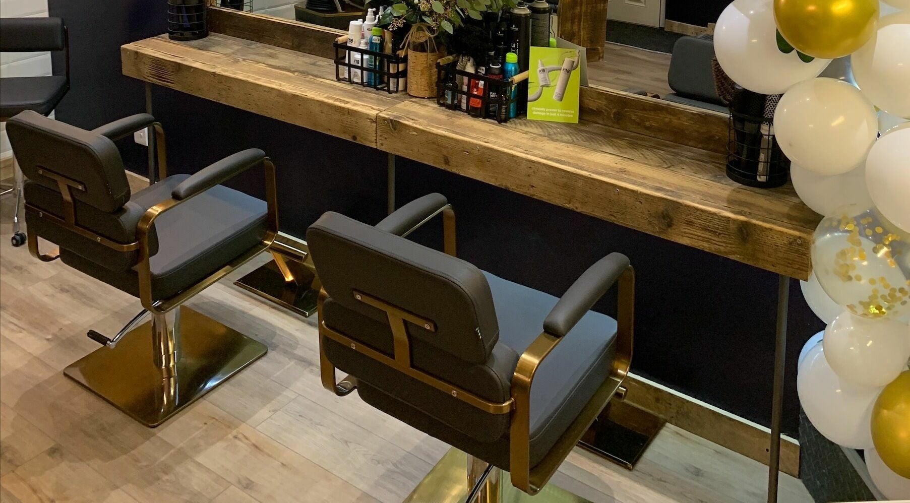 Stylish salon chairs and wooden counter at Headhouse, Horsforth, England, GB, showcasing modern elegance.