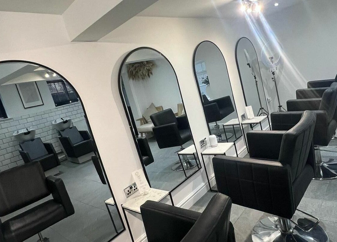 Modern salon chairs and mirrors at SW Hair Extensions in Watnall, England, GB, offering comfortable styling.