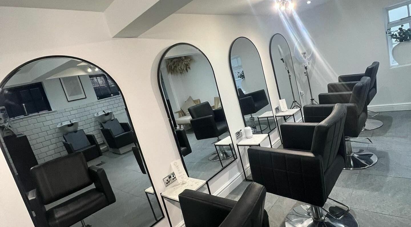Modern salon chairs and mirrors at SW Hair Extensions in Watnall, England, GB, offering comfortable styling.