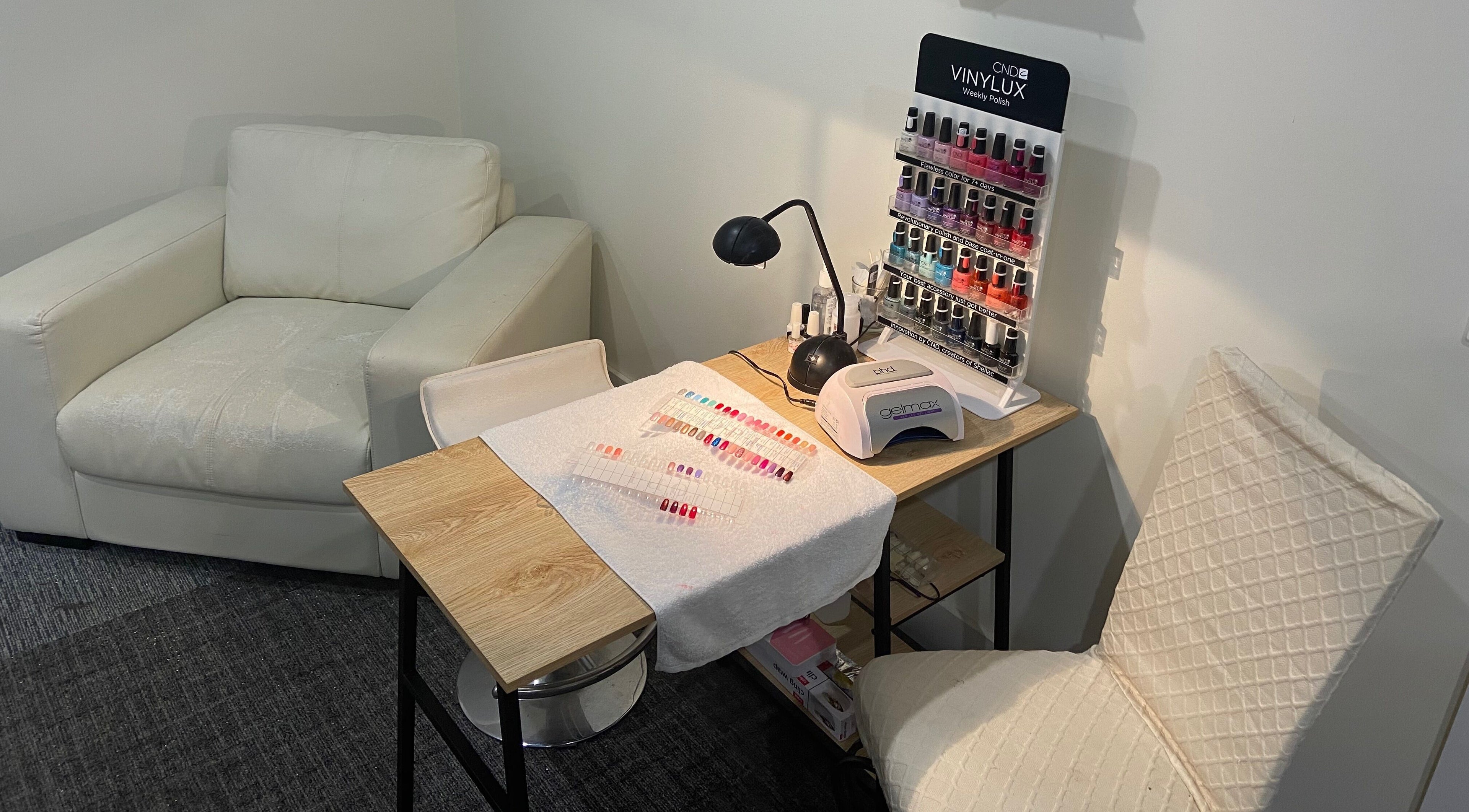 Cozy nail care setup at Sunset Waxing Beauty Studio, Melbourne, Victoria, AU, featuring polish selection.