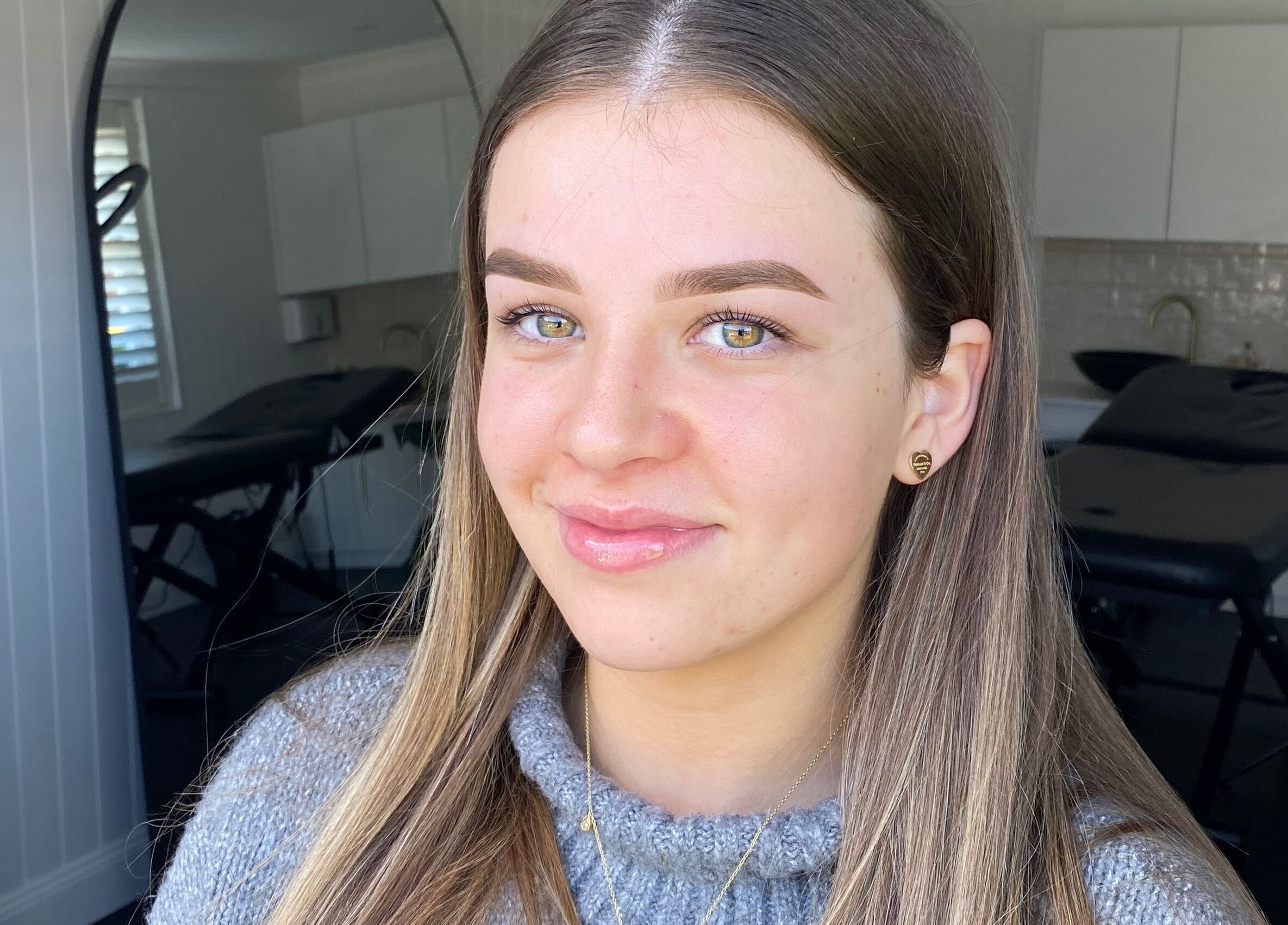 Smiling woman at Glow by Rachel, Sydney, New South Wales, AU, showcasing natural beauty and wellness.