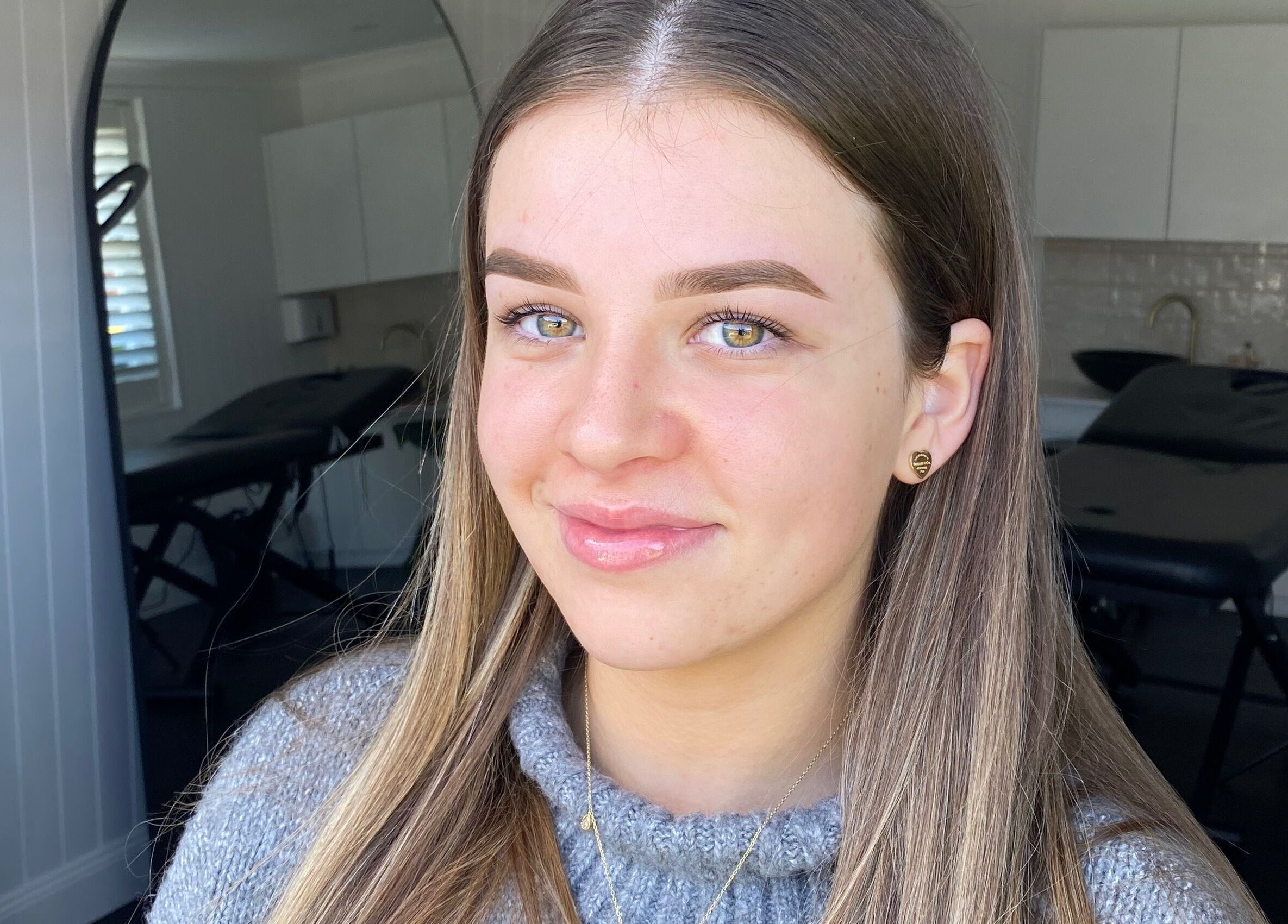 Smiling woman at Glow by Rachel, Sydney, New South Wales, AU, showcasing natural beauty and wellness.