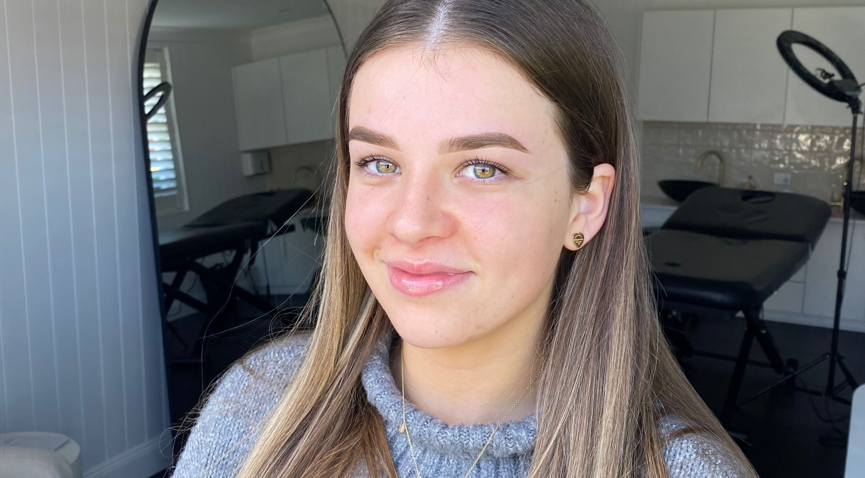 Smiling woman at Glow by Rachel, Sydney, New South Wales, AU, showcasing natural beauty and wellness.