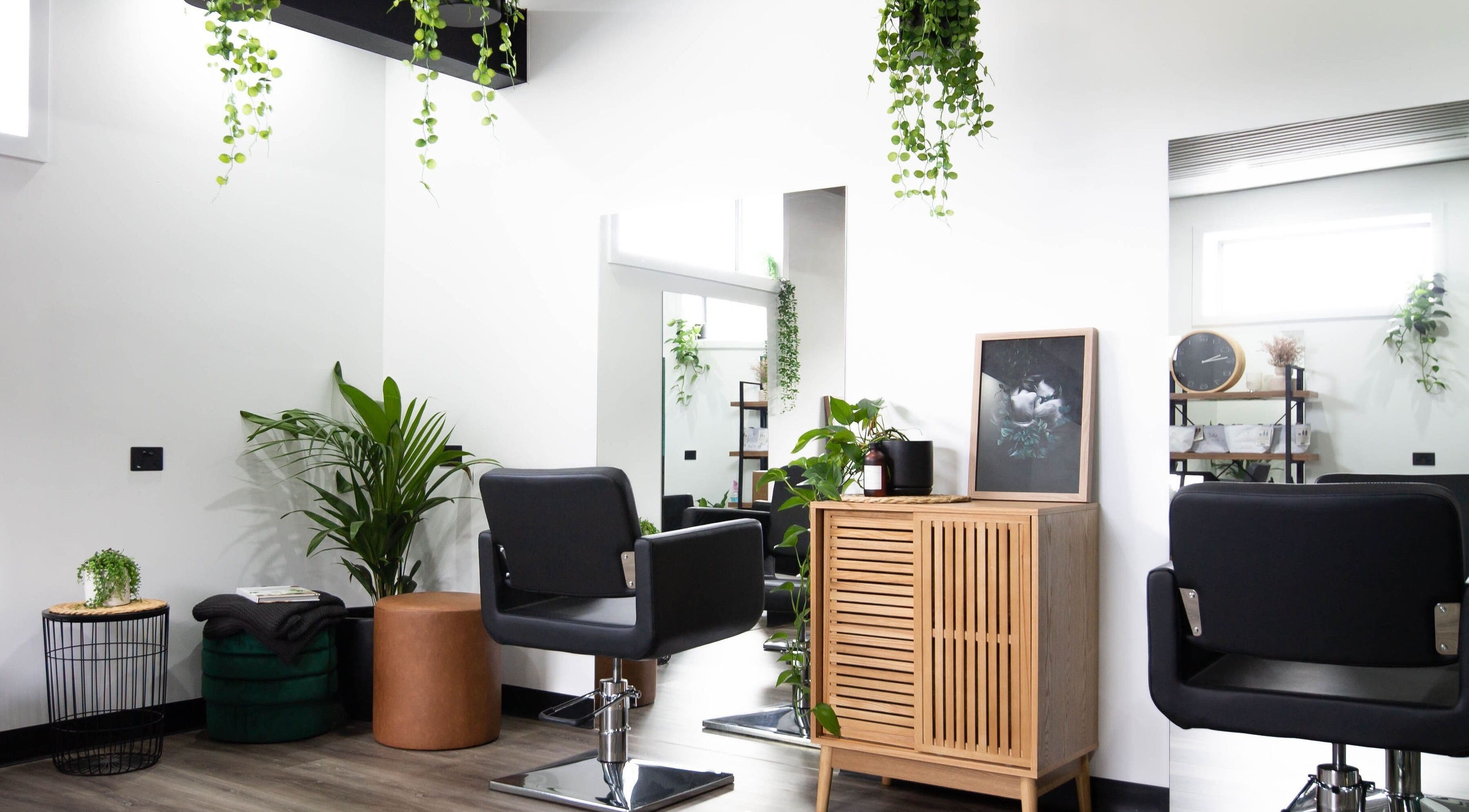 Elegant interior of Aspen Hair in South Launceston, Tasmania, AU. Stylish salon chairs and greenery create a serene vibe.