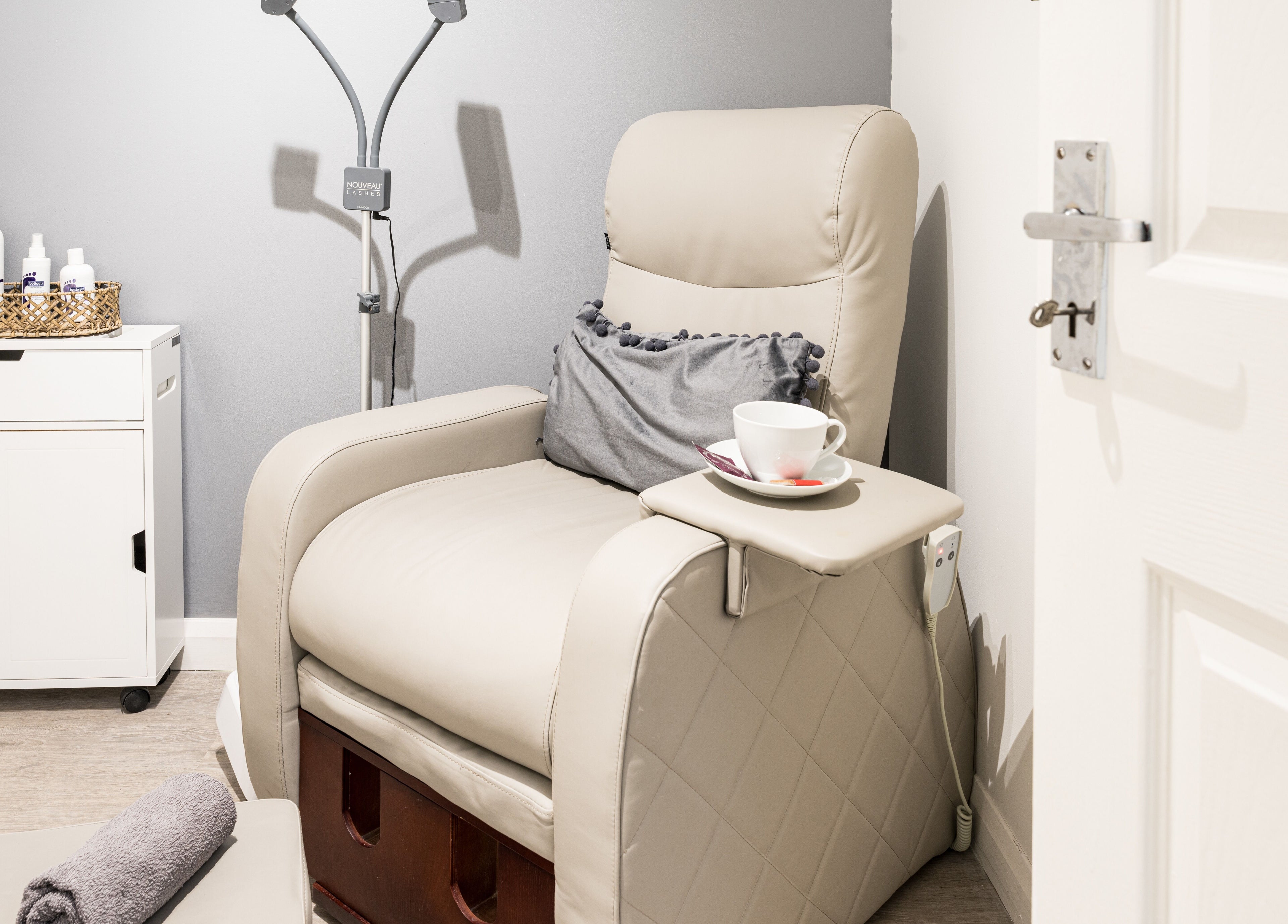 Relaxing treatment area at SB Studio, Coulsdon, England, GB with a plush chair and modern decor.