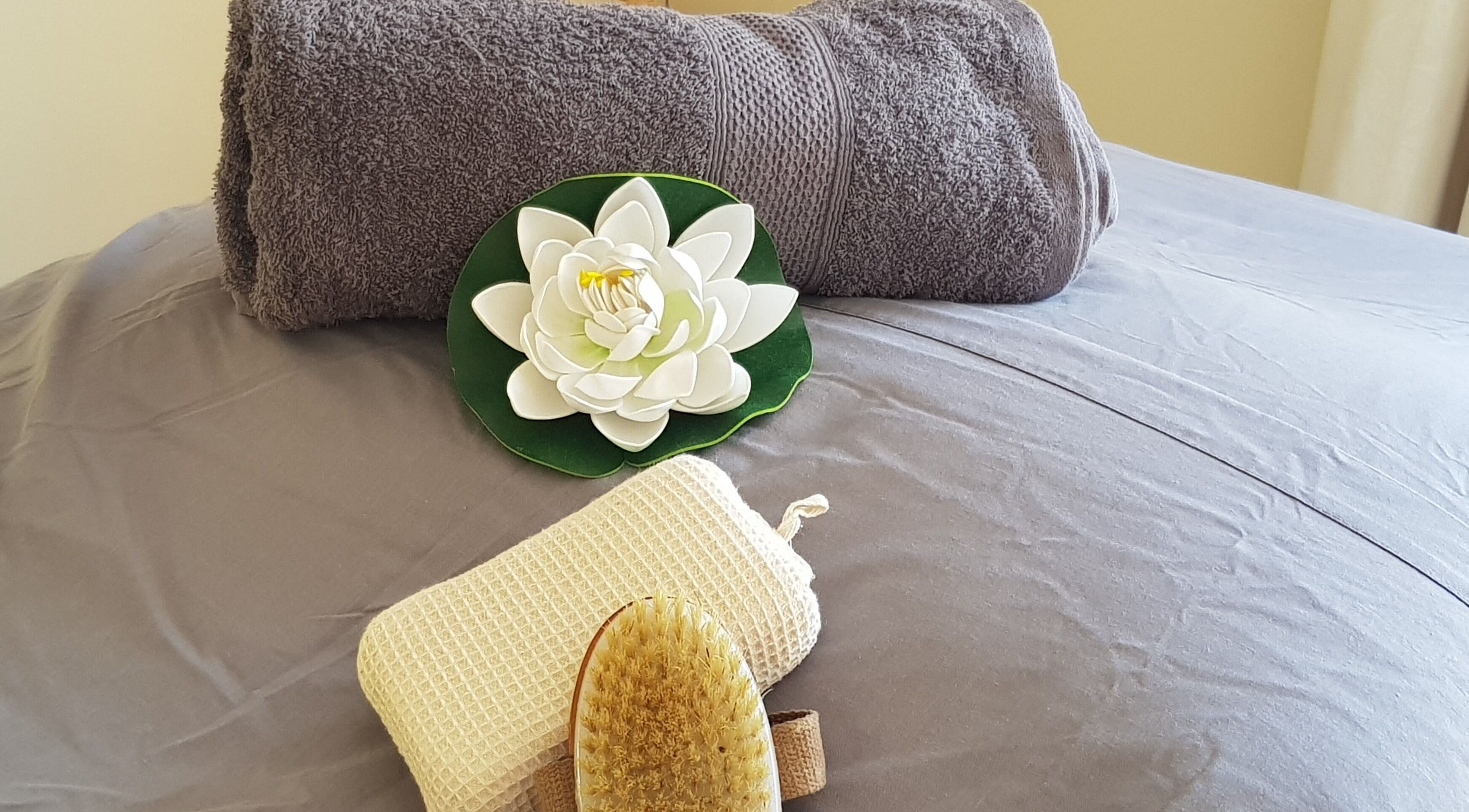 Spa essentials displayed with a flower at Mobile Service, Cape Town, Western Cape, ZA.