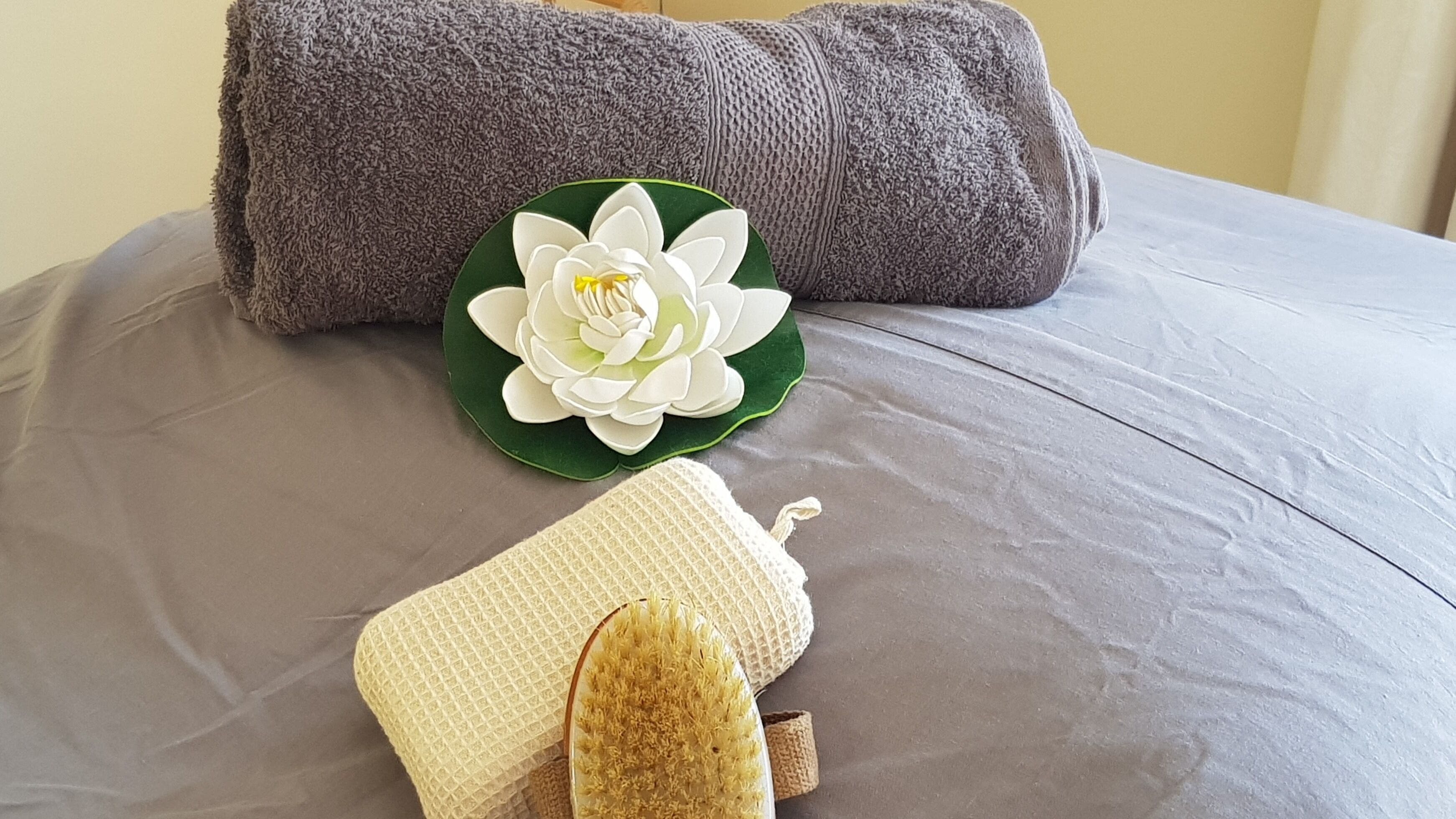 Spa essentials displayed with a flower at Mobile Service, Cape Town, Western Cape, ZA.