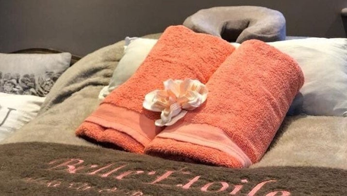 Belle Etoile Beauty massage table with plush towels and serene setting in Guernsey, GB.