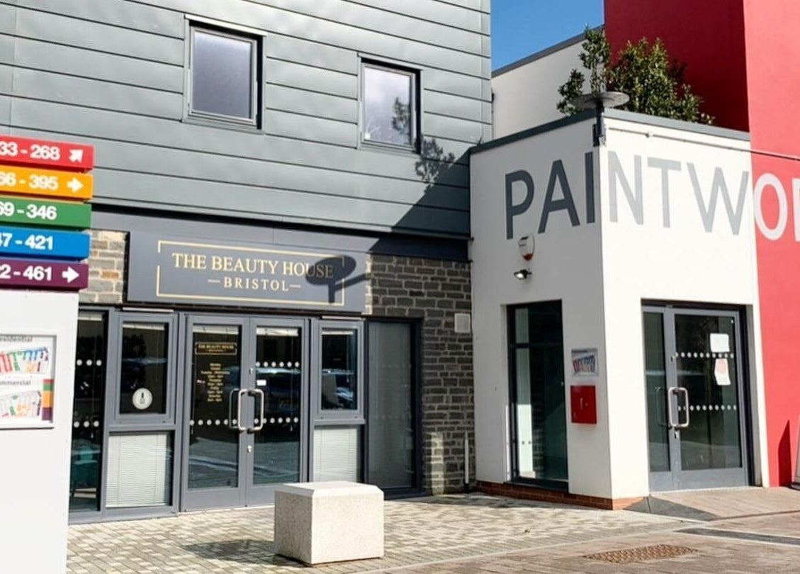 Front view of The Beauty House at Bristol, England, GB with vibrant signages and modern architecture.