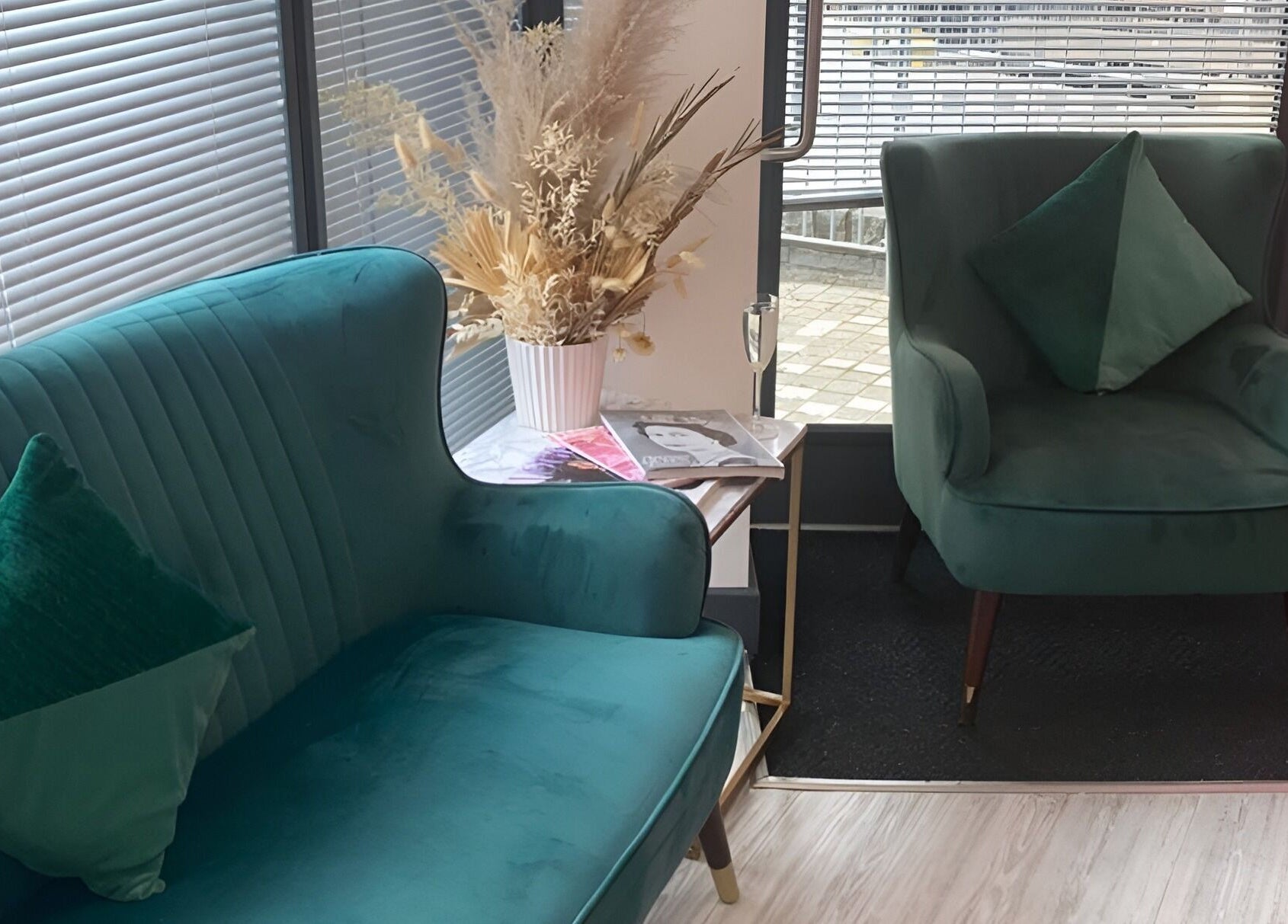 Stylish green seating area at The Beauty House, Bristol, England, GB, with elegant decor and natural light.