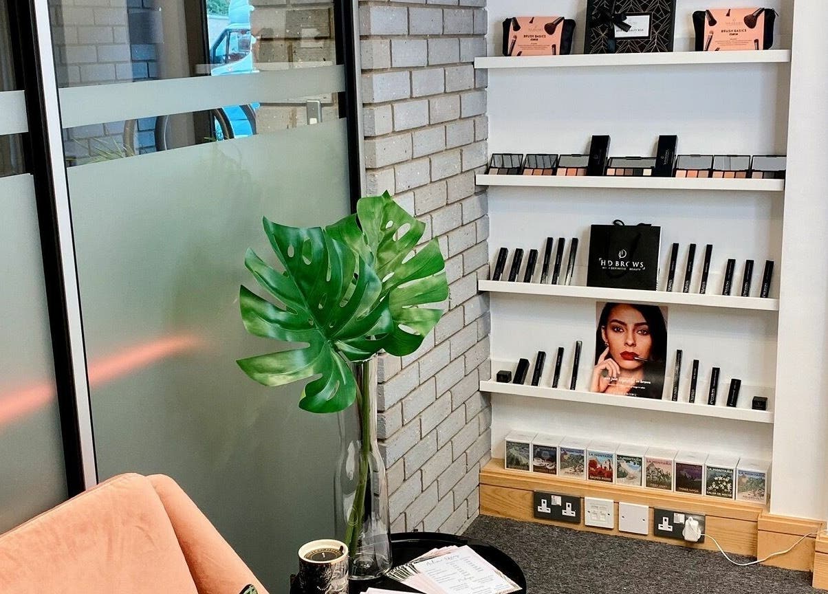 StefyBrows Harpenden, England, GB waiting area with modern decor and beauty products displayed.