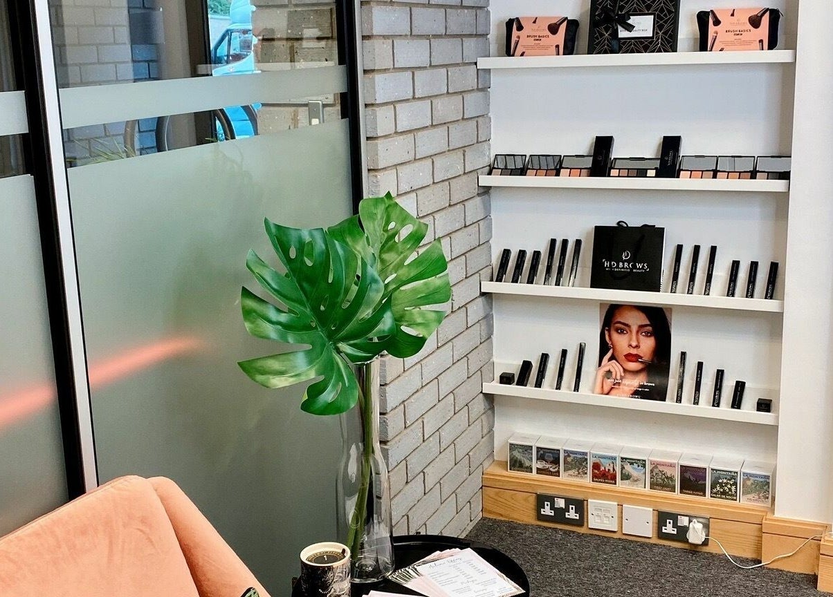 StefyBrows Harpenden, England, GB waiting area with modern decor and beauty products displayed.