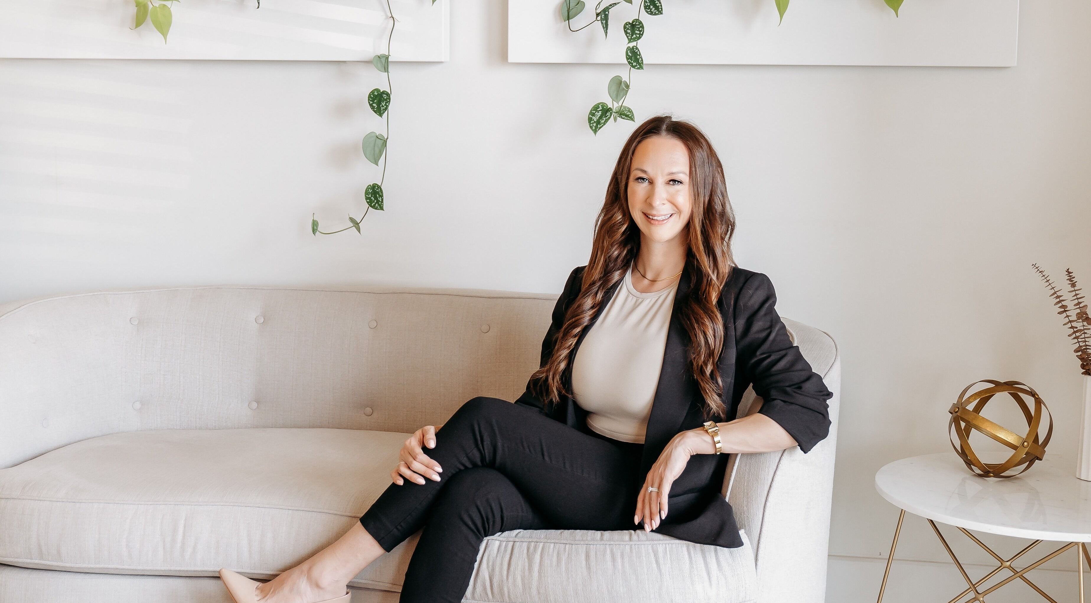 Professional seated at Hush Rejuvenation Clinic in Kingston, Ontario, CA, showcasing elegant ambiance.