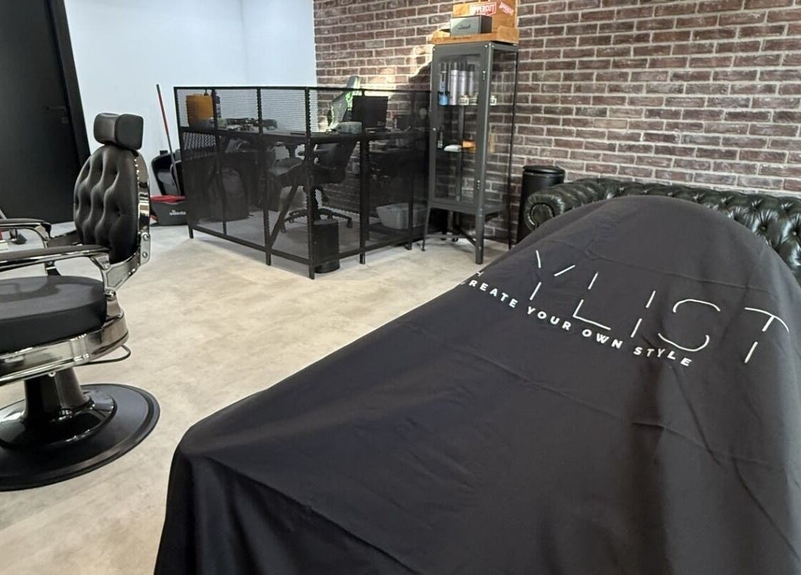 Modern barber chair in Panther Cuts salon in Pafos, Pafos, CY with chic decor and brick wall.