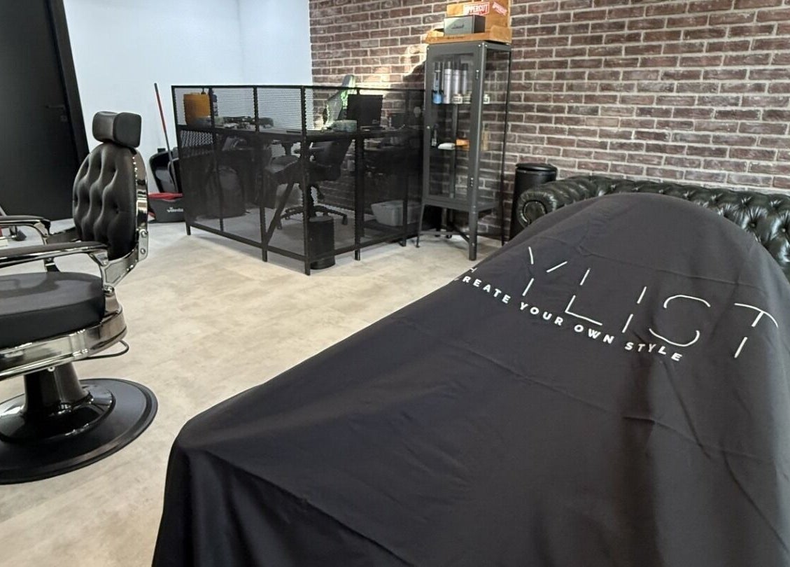 Modern barber chair in Panther Cuts salon in Pafos, Pafos, CY with chic decor and brick wall.