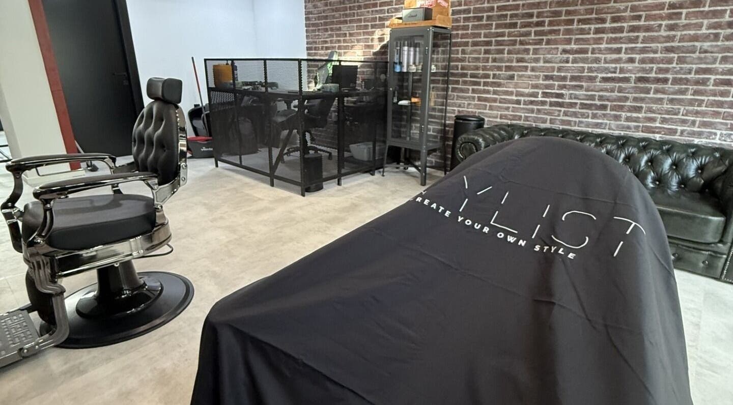 Modern barber chair in Panther Cuts salon in Pafos, Pafos, CY with chic decor and brick wall.