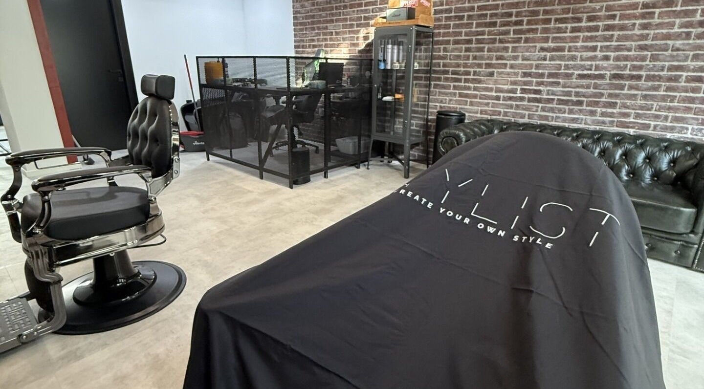 Modern barber chair in Panther Cuts salon in Pafos, Pafos, CY with chic decor and brick wall.