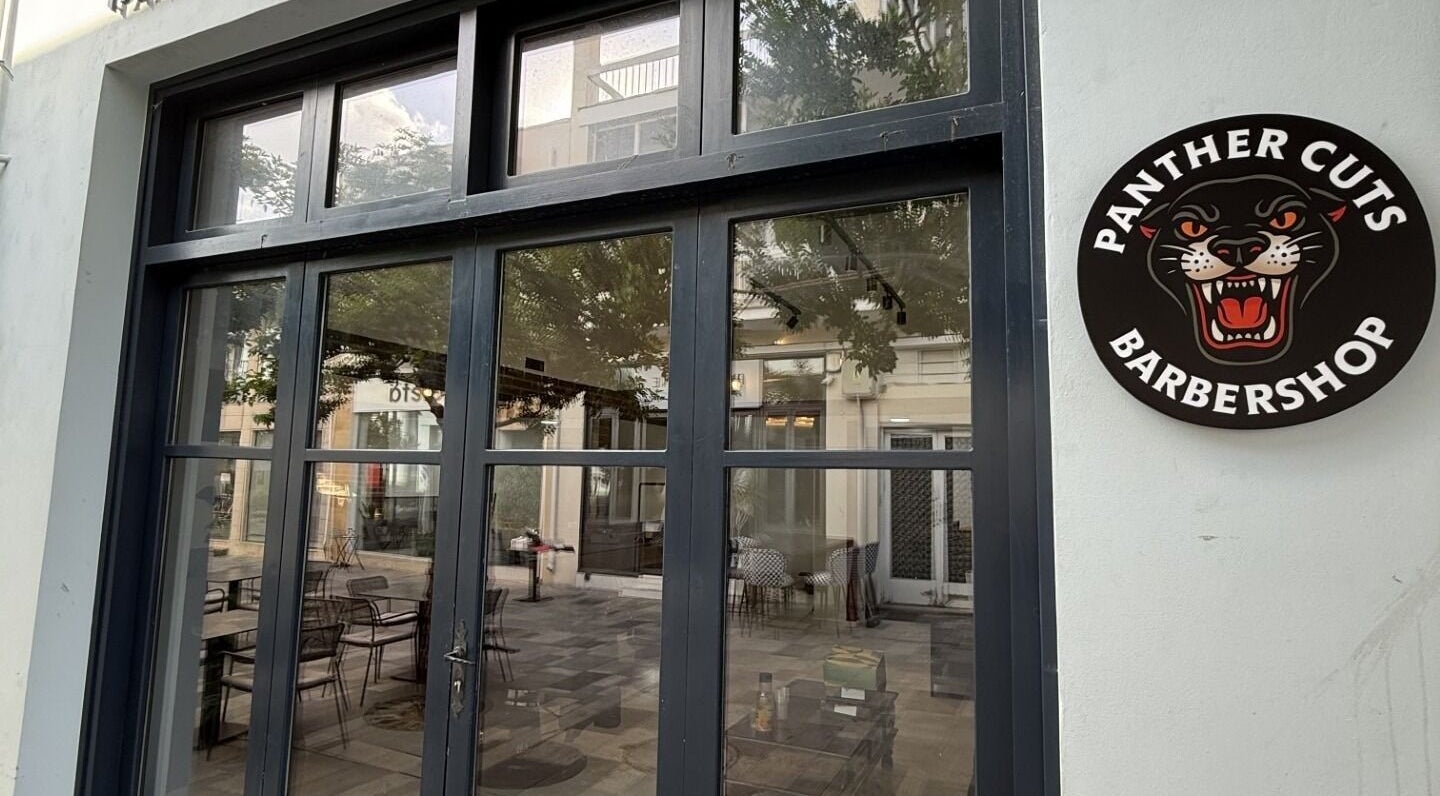 Front view of Panther Cuts barbershop in Pafos, Pafos, CY showcasing glass doors and logo.
