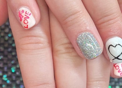 Heart-themed nail art with glitter by Polished Designs by Danielle in Mount Horeb, Wisconsin, US.