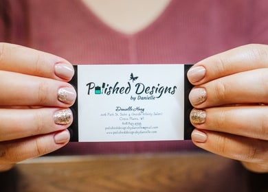 Polished Designs by Danielle business card held with stylish nails in Mount Horeb, Wisconsin, US.