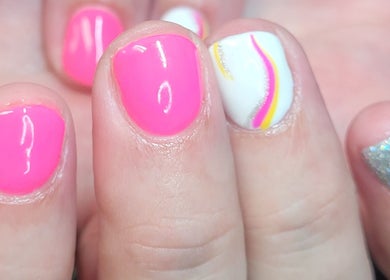 Vibrant nail art with pink, white, and sparkly designs at Polished Designs by Danielle, Mount Horeb, Wisconsin, US.