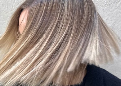 Blonde balayage hairstyle at Salome the Salon Stellenbosch, Western Cape, ZA, highlights its graceful movement.