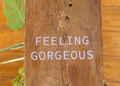 Rustic wooden sign with 'Feeling Gorgeous' at Salome the Salon Stellenbosch, Western Cape, ZA.