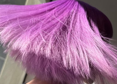 Vibrant violet hair styled at Salome the Salon Stellenbosch, Western Cape, ZA, capturing dynamic color and shine.