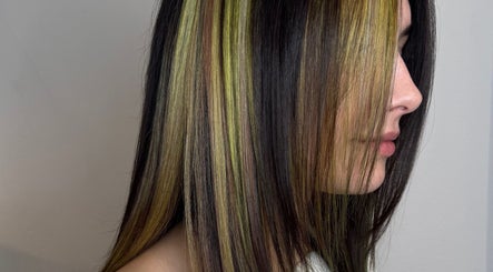 Highlighted hair transformation at Salome the Salon Stellenbosch, Western Cape, ZA, showcasing vibrant color streaks.