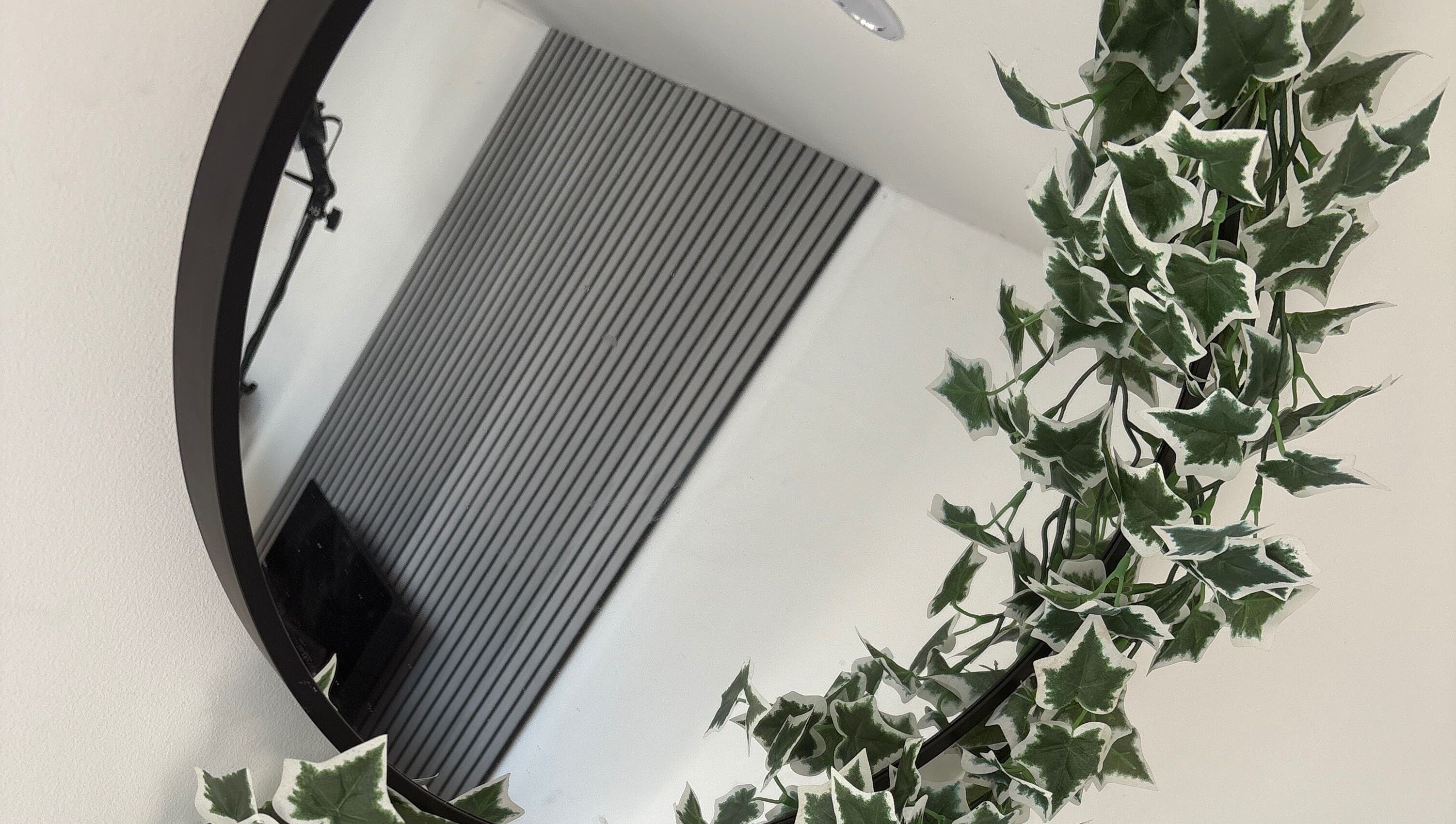 Elegant round mirror with lush ivy at Forever Graceful Beauty & Aesthetics, Sunderland, England, GB.