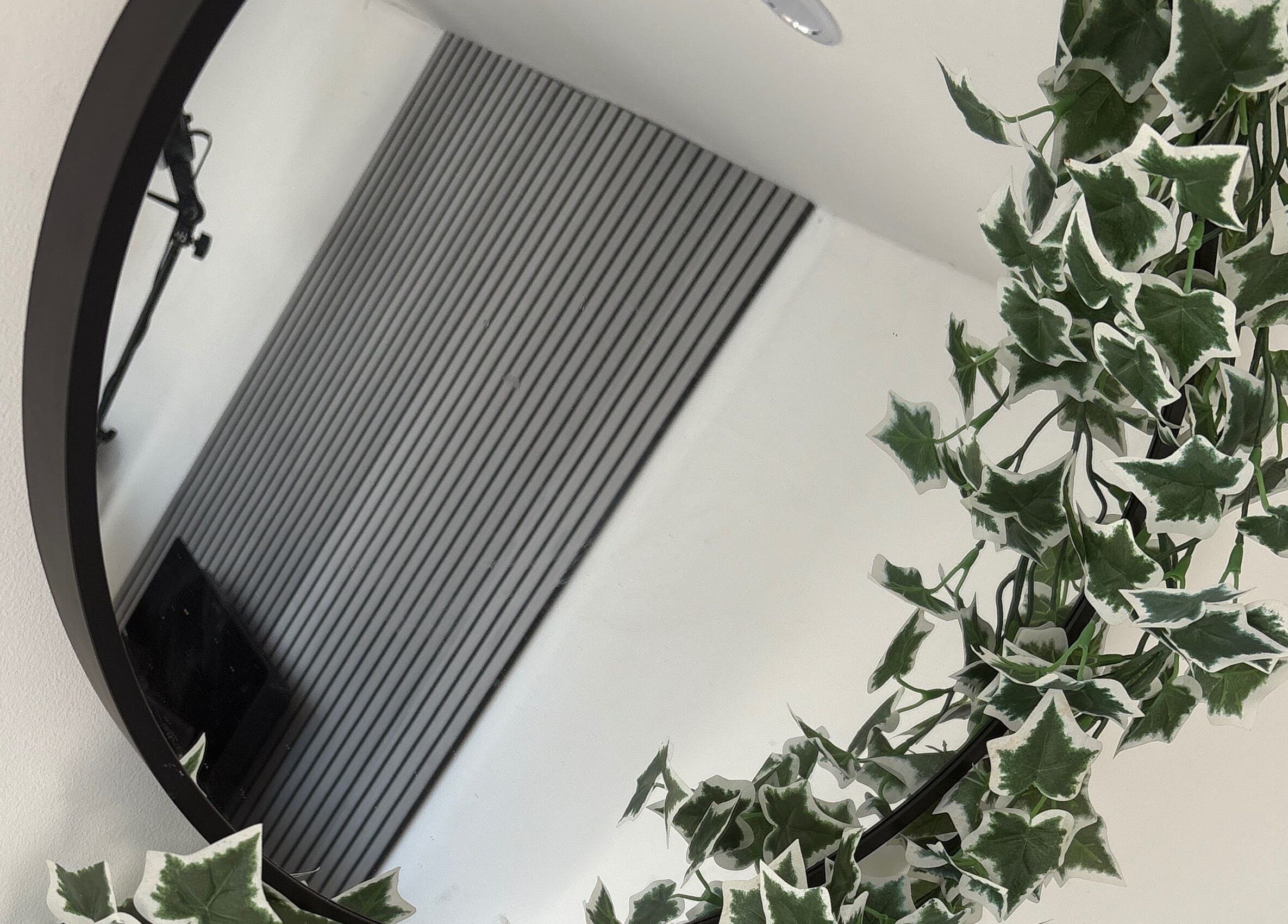 Elegant round mirror with lush ivy at Forever Graceful Beauty & Aesthetics, Sunderland, England, GB.