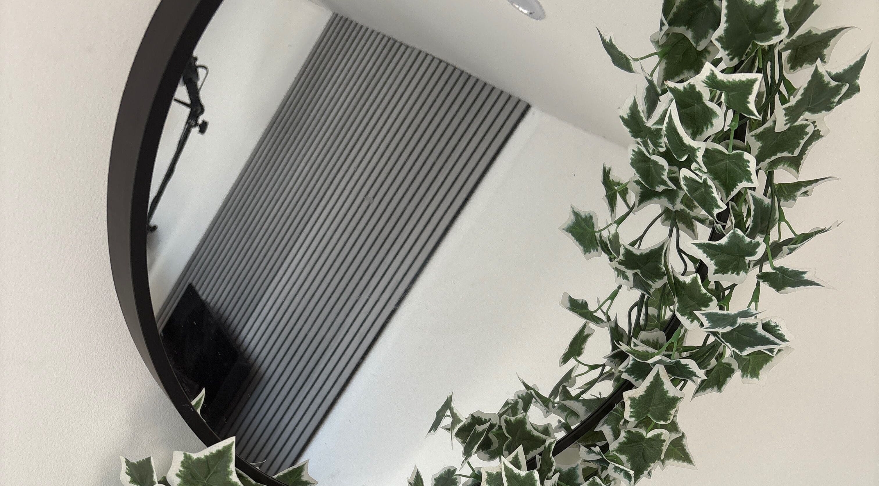 Elegant round mirror with lush ivy at Forever Graceful Beauty & Aesthetics, Sunderland, England, GB.